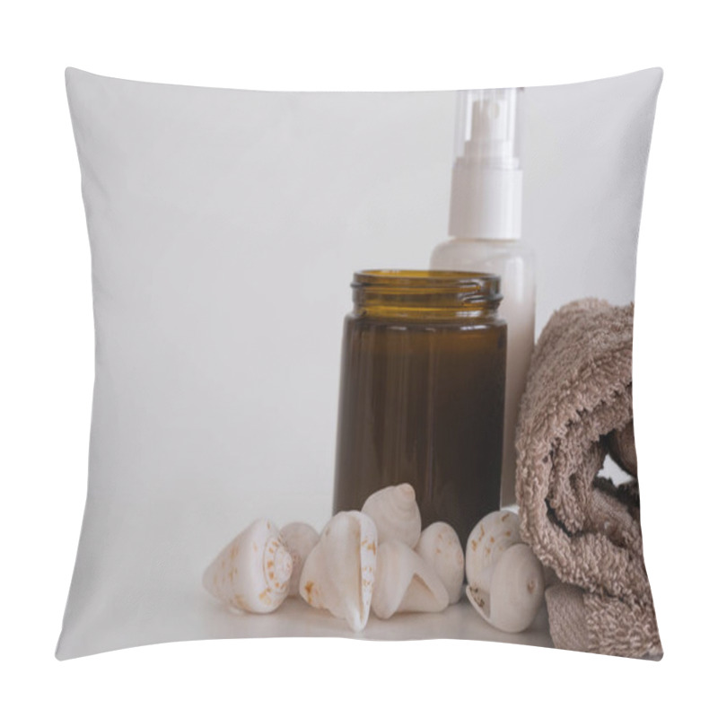 Personality  A Brown Rolled Towel, An Amber Jar, And A Bottle Surrounded By White Seashells On A Clean White Background. The Arrangement Highlights Spa And Coastal Aesthetics Pillow Covers