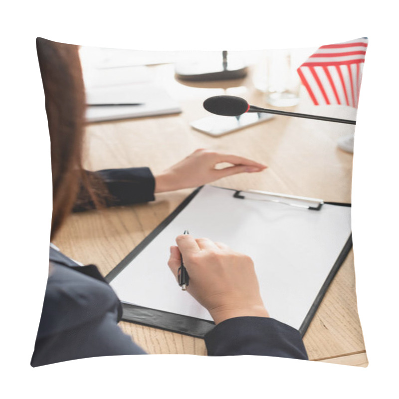 Personality  Cropped View Of Brunette Woman Holding Pen Sitting Near Clipboard With Blank Paper And Microphone On Blurred Background Pillow Covers