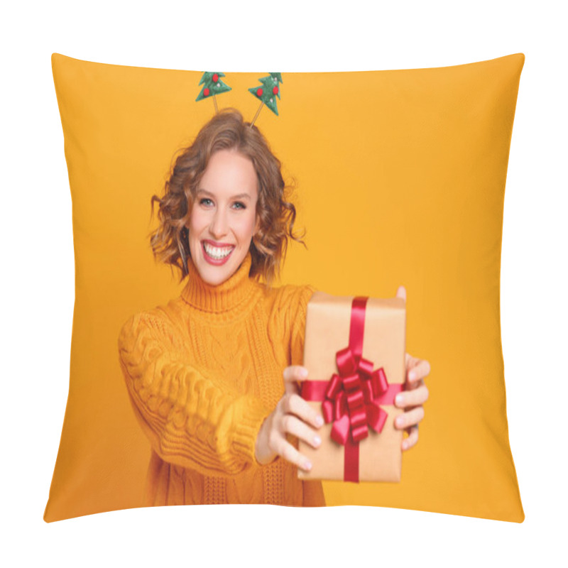 Personality  Happy Young Woman In Sweater And Headband Showing Wrapped Present And Looking At Camera With Smile On Christmas Day Against Yellow Backgroun Pillow Covers