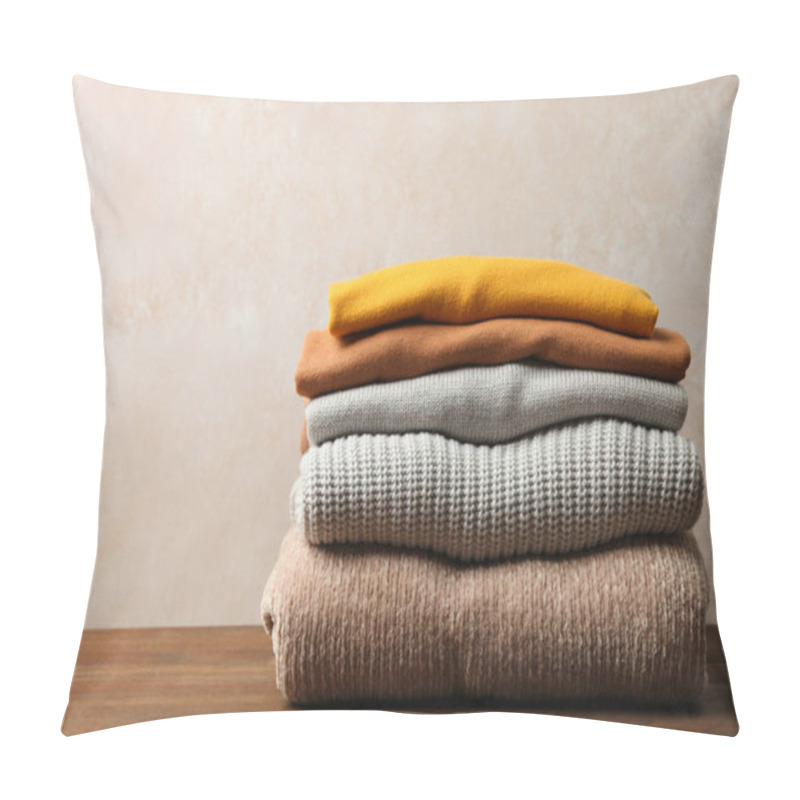 Personality  Pile Of Female Warm Sweaters On Wooden Table On Neutral Background. Concept Autumn Clothes. Pillow Covers