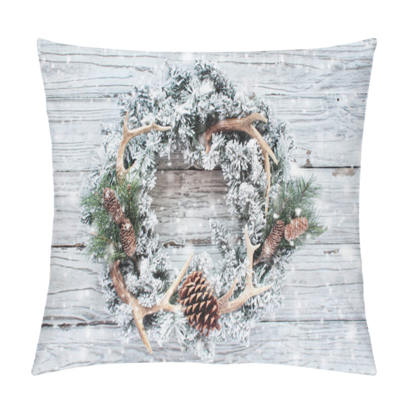 Personality  Flocked country or hunters Christmas wreath over white wood background with falling snow. Made with pine cones, fir branches, and deer antlers. Handmade decor for winter holidays. Top view with copy space pillow covers