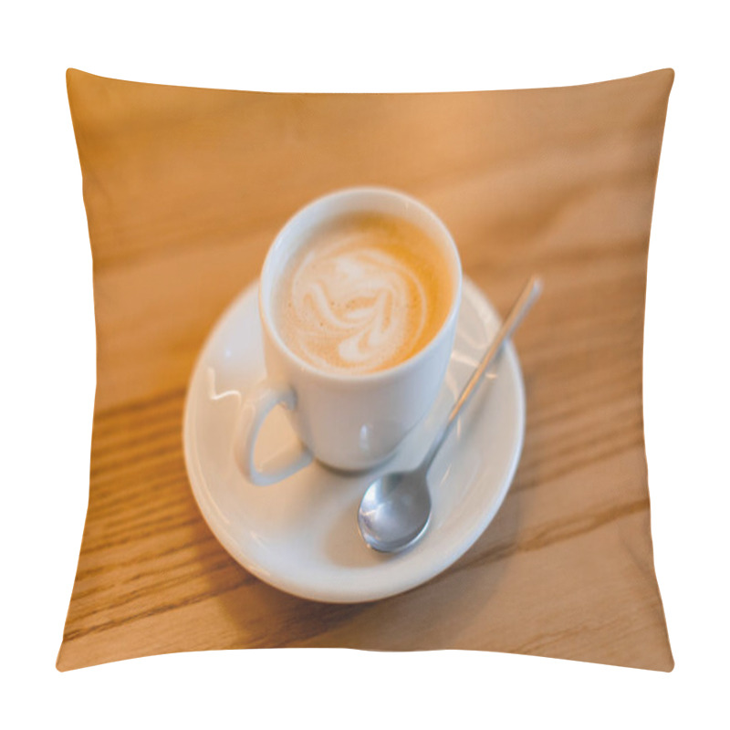 Personality  A Classic Cappuccino With Delicate Latte Art Served In A White Ceramic Cup On A Matching Saucer With A Silver Spoon. The Warm Wooden Table Adds A Cozy Coffee Shop Ambiance. Pillow Covers