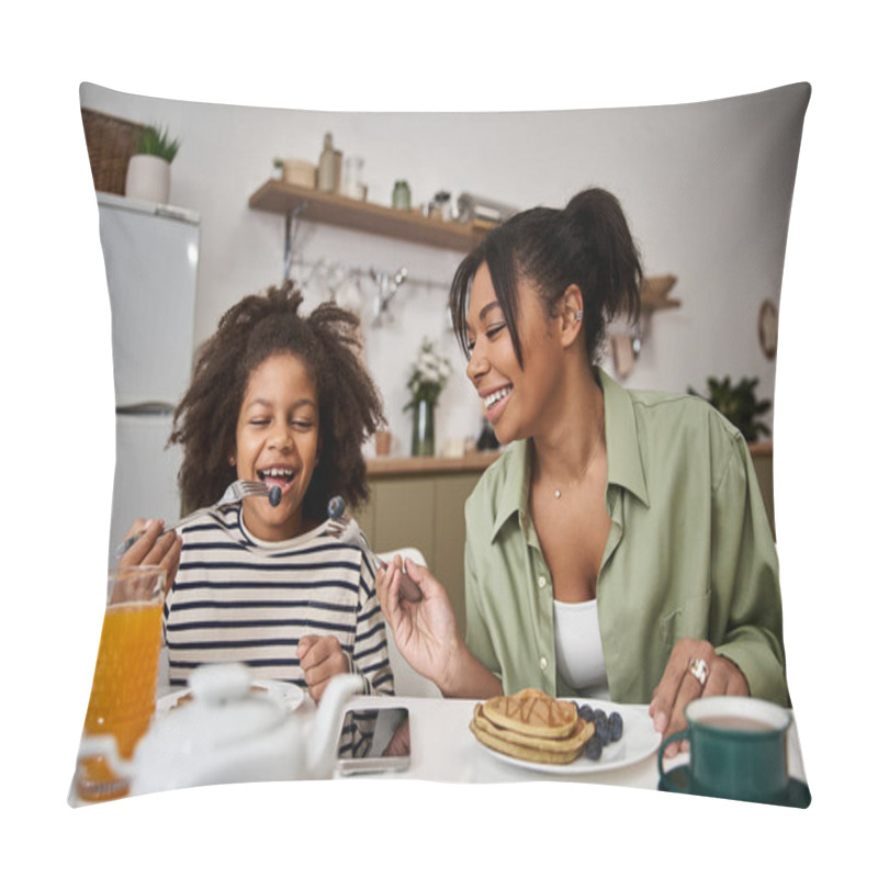 Personality  Mother Happily Feeds Her Daughter Breakfast While They Share Smiles In A Bright Kitchen. Pillow Covers