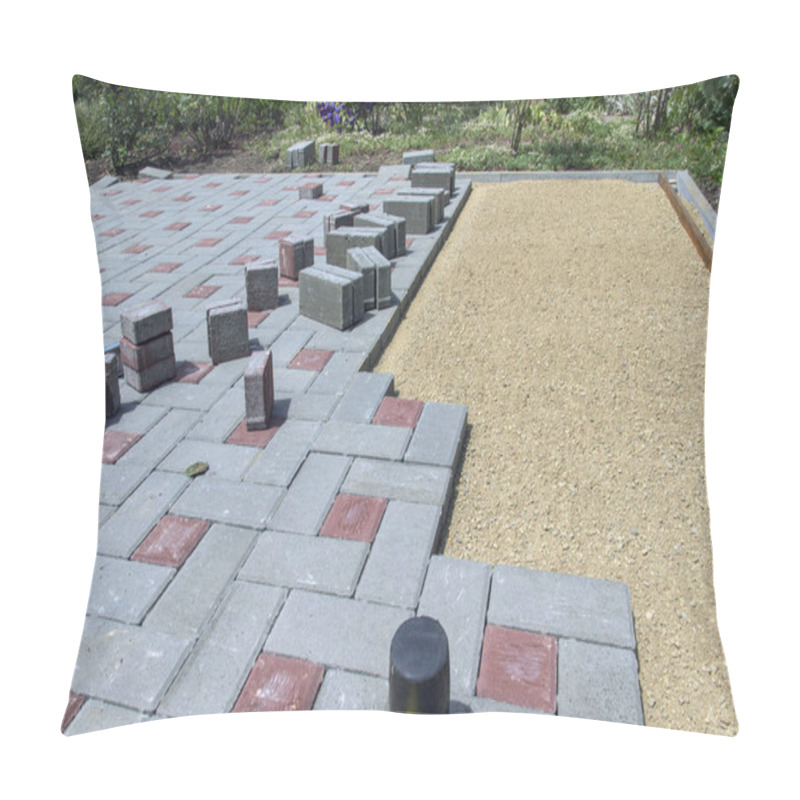 Personality  Laying paving stones on a garden path. Laying gray concrete paving slabs in the yard on a flat sandy foundation pillow covers