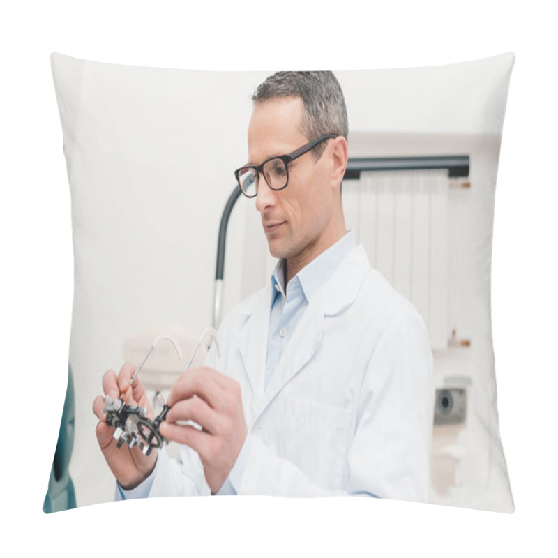 Personality  Optometrist In White Coat Looking At Trial Frame In Hands In Clinic Pillow Covers