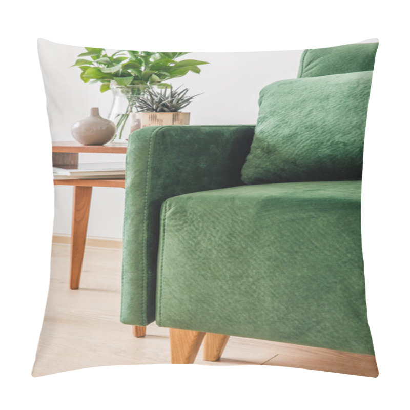 Personality  Close Up View Of Green Sofa With Pillow And Blanket Near Wooden Coffee Table With Plants  Pillow Covers