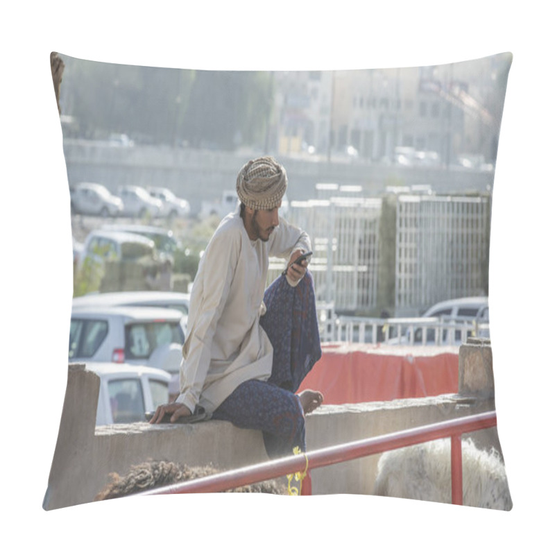 Personality  Nizwa, Oman, 10th November 2017: Omani Young Man Using Smartphone Pillow Covers