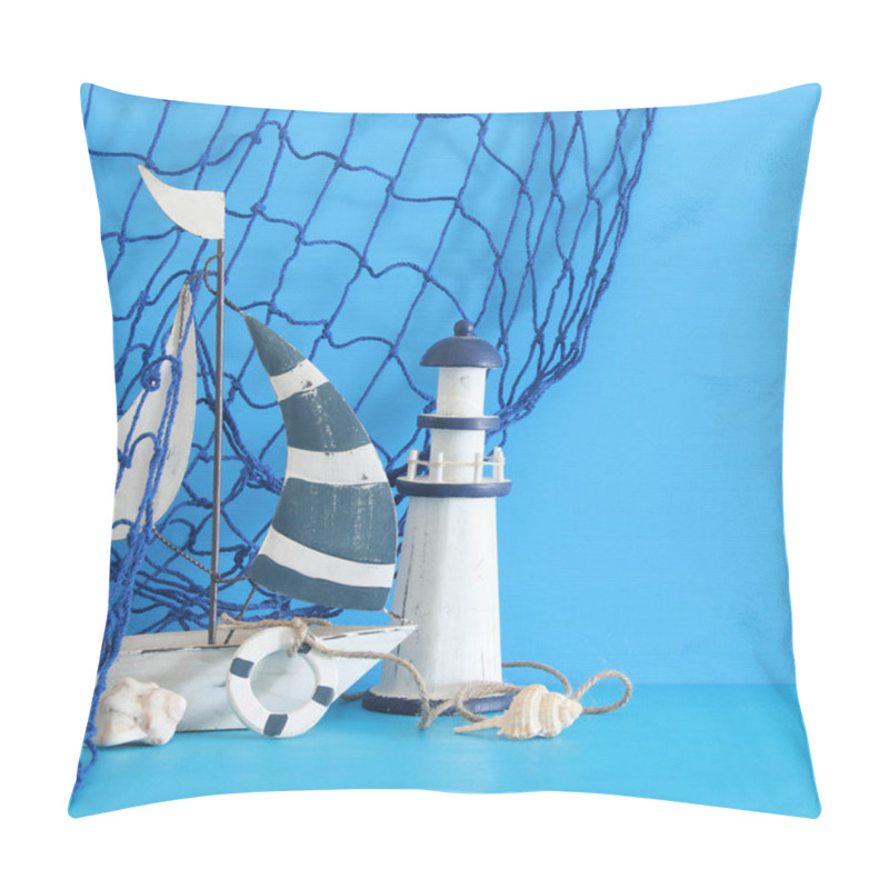 Personality  Nautical Concept With White Decorative Sail Boat, Lighthouse, Seashells And Fishnet Over Blue Wooden Table And Background. Pillow Covers