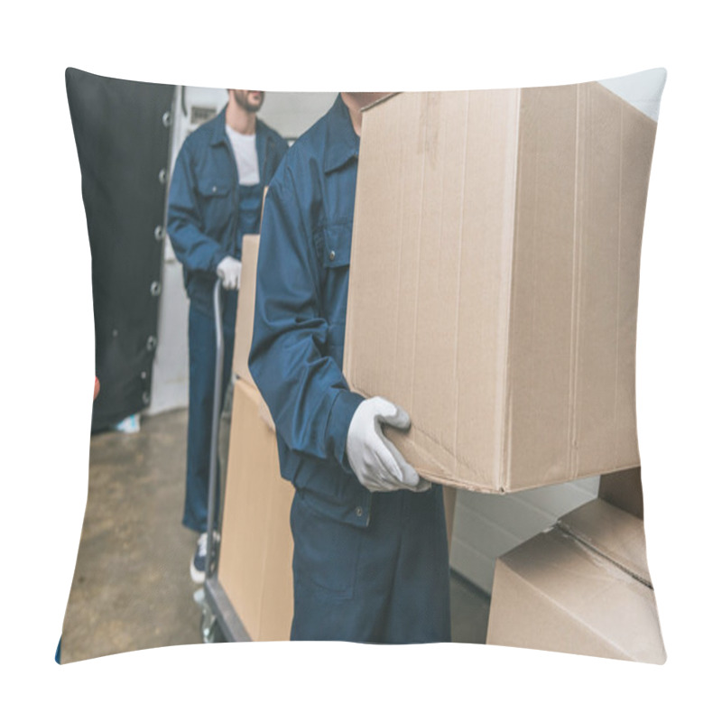 Personality  Cropped View Of Two Movers In Uniform Transporting Cardboard Boxes With Hand Truck In Warehouse Pillow Covers