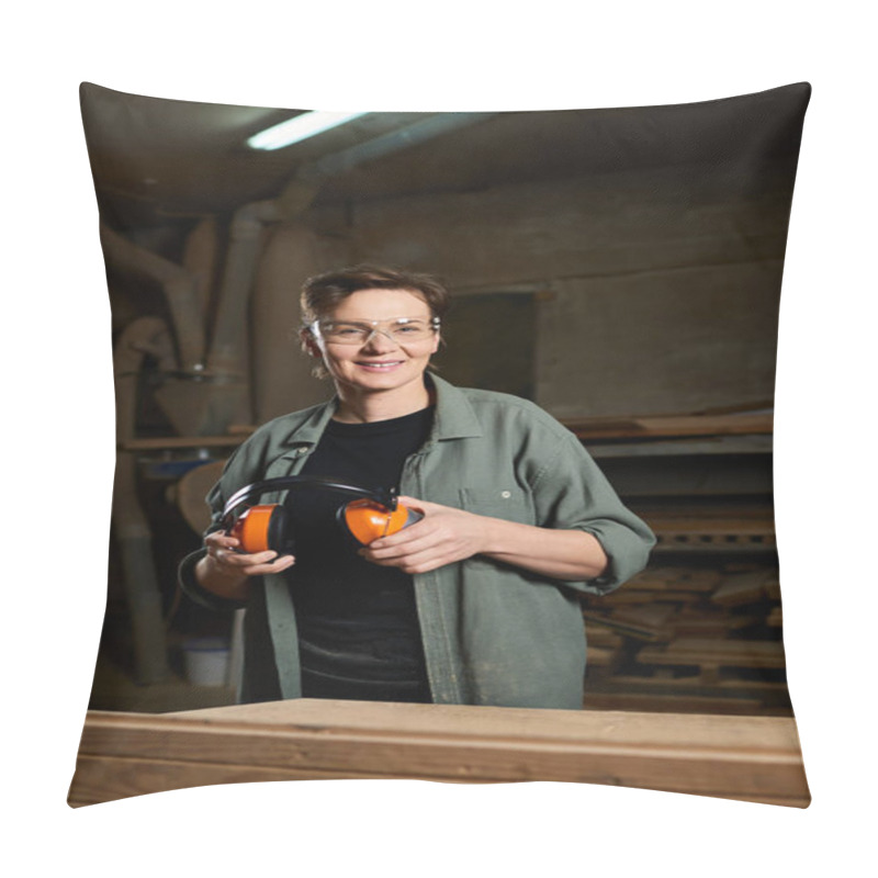 Personality  In A Well-lit Workshop, A Female Carpenter Holds Her Ear Protection, Ready To Craft Her Next Woodworking Project. Pillow Covers