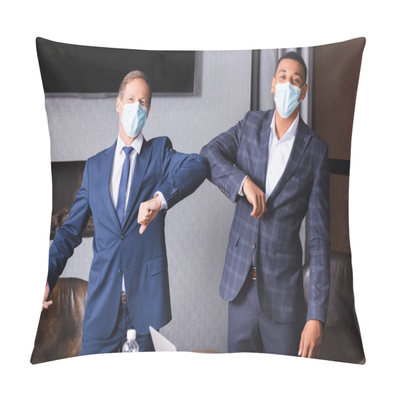 Personality  Multicultural Businessmen In Medical Masks Looking At Camera While Greeting Each Other With Elbows In Meeting Room Pillow Covers