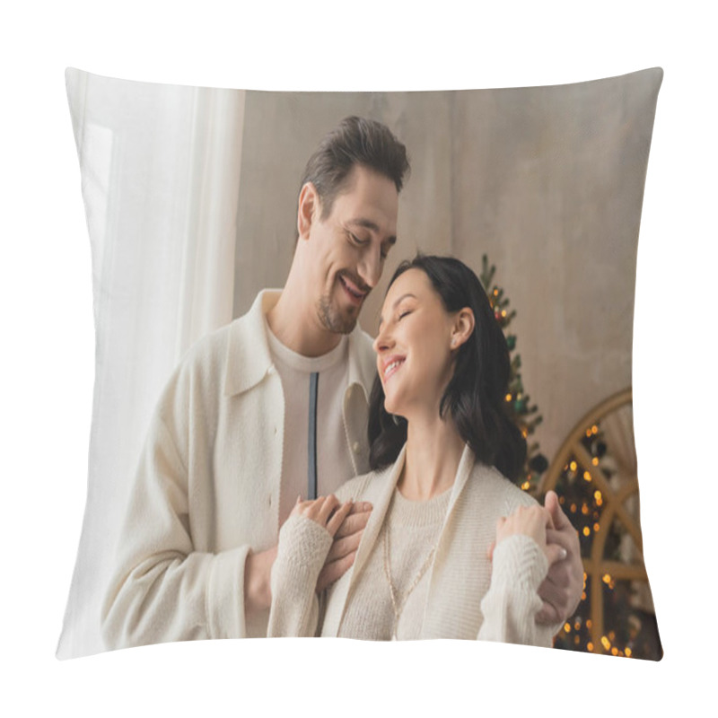 Personality  Cheerful Man With Beard Hugging Happy Wife In Cozy Home Wear Near Blurred Christmas Tree On Backdrop Pillow Covers