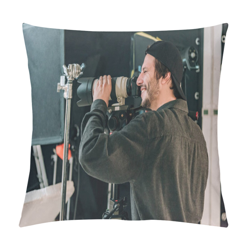 Personality  Side View Of Smiling Videographer With Camera In Photo Studio Pillow Covers