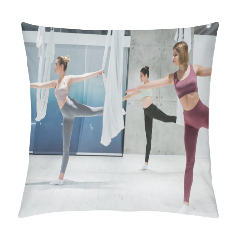 Personality  Three Young Women Practicing Warrior Pose Near Fly Yoga Hammocks In Sports Center Pillow Covers