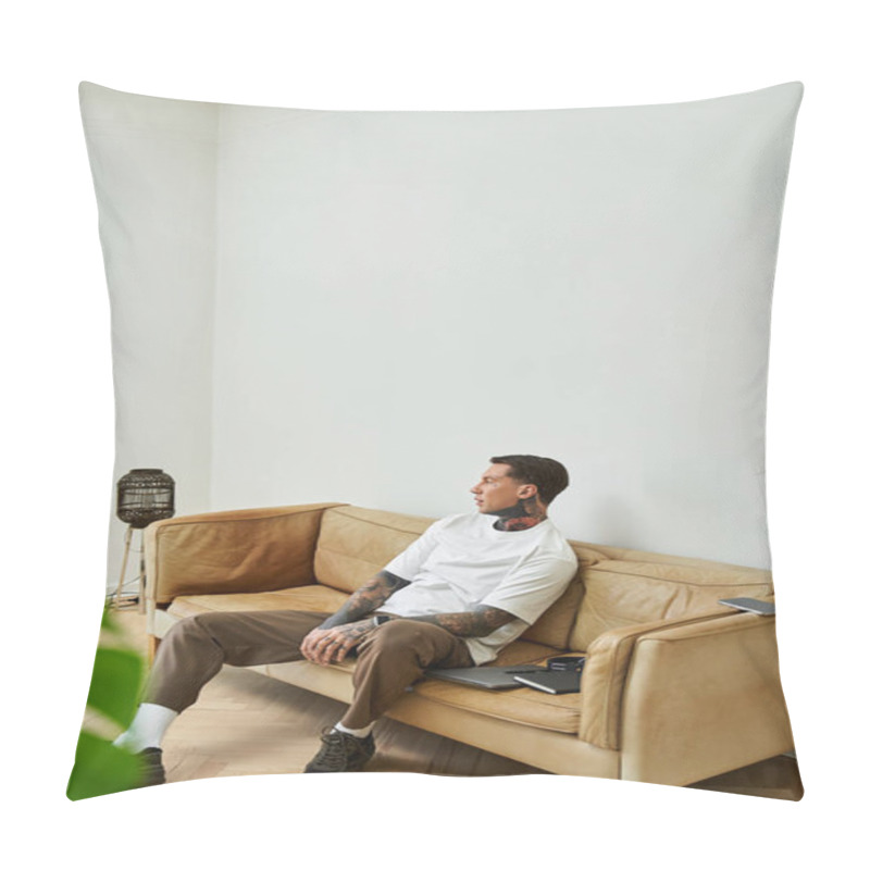 Personality  A Young Man Sits Pensively On His Sofa At Home, Enjoying A Quiet Moment In A Chic, Minimalist Space. Pillow Covers