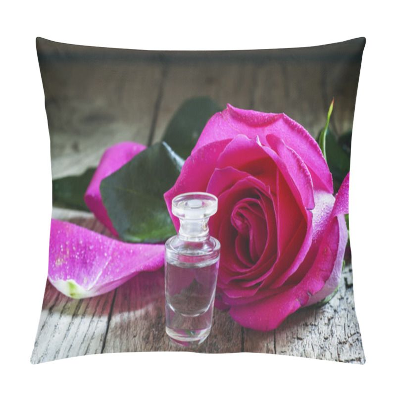 Personality  Rose Essential Oil In A Small Bottle And Pink Rose Pillow Covers