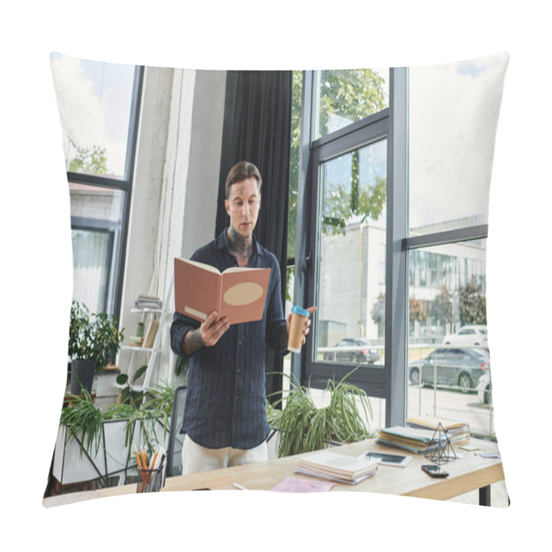 Personality  A Young Coworker Stands At A Desk, Reading From A Binder While Holding A Drink. Pillow Covers