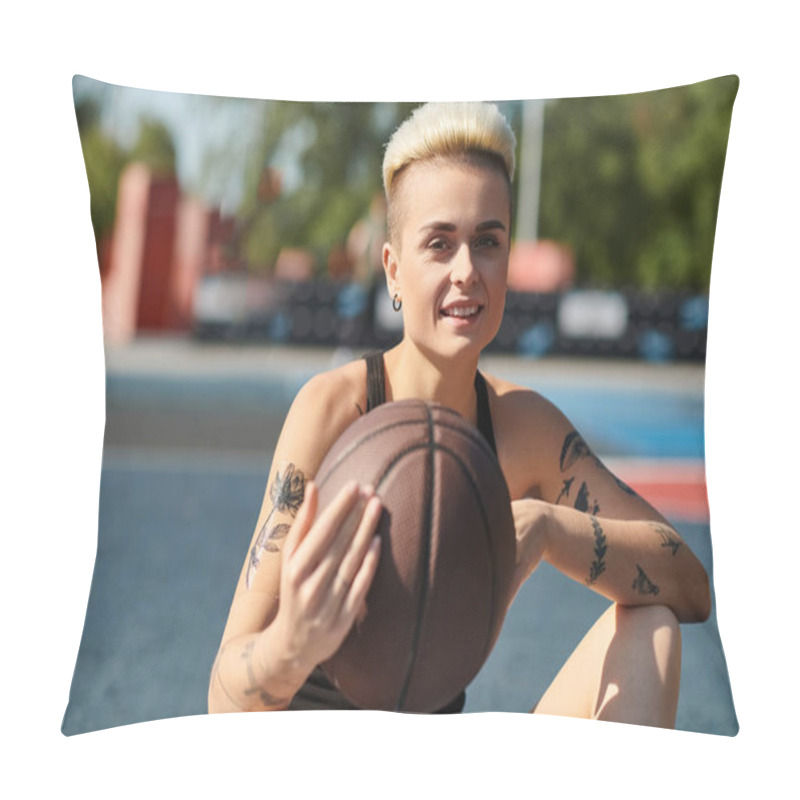 Personality  A Young Woman With Short Hair And Tattoos Sits On The Ground, Cradling A Basketball With A Look Of Determination. Pillow Covers