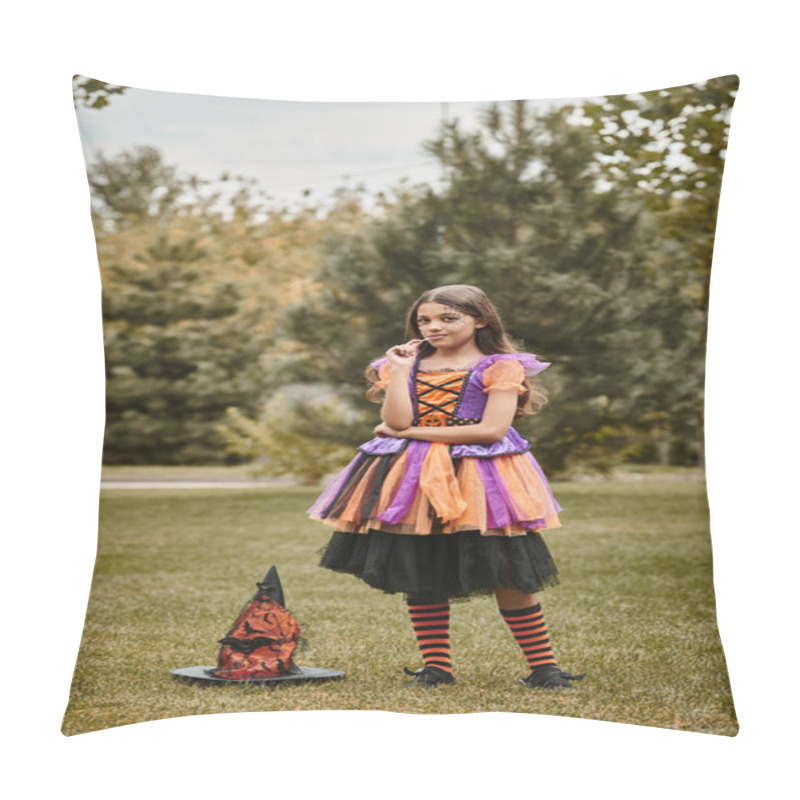 Personality  Cute Girl In Halloween Costume Standing With Lollipop In Mouth Near Pointed Hat On Green Grass Pillow Covers