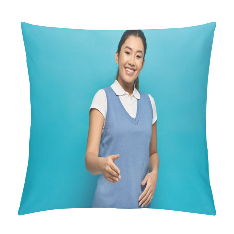 Personality  A Young Asian Woman In A Smart Casual Outfit Smiles And Offers Her Hand For A Handshake Against A Bright Blue Background. Pillow Covers