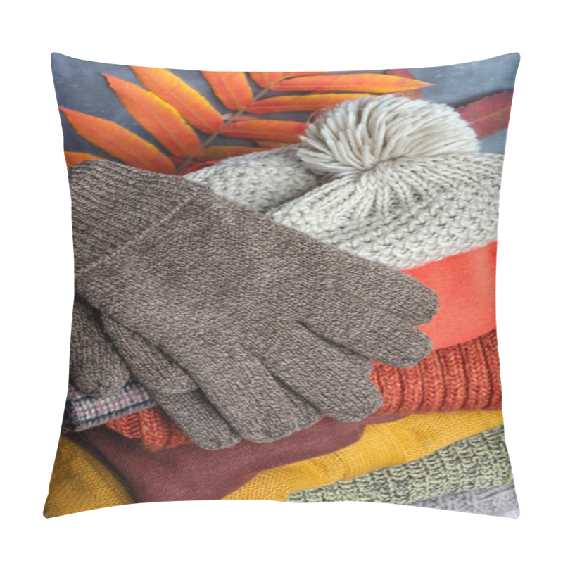 Personality  Stack Of Folded Warm Knitted Women's Sweaters, Scarf, Hat With Pompom, Gloves In Warm Colors And Bright Autumn Leaves. Closeup Pillow Covers