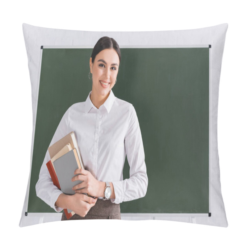 Personality  Teacher With Books Smiling At Camera In Classroom  Pillow Covers