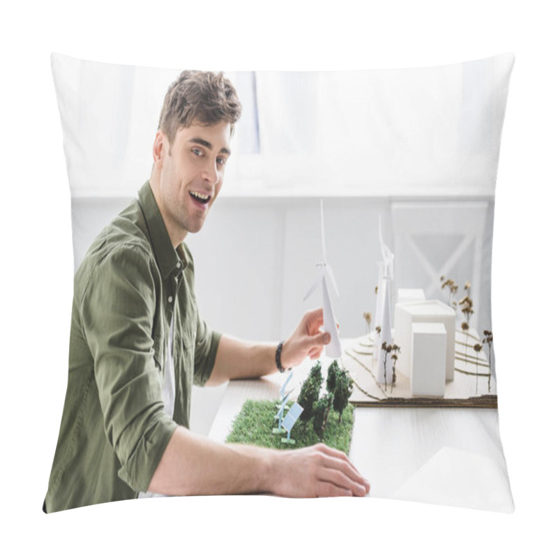 Personality  Architect In Green Shirt Sitting At Table And Holding Windmill Model In Office Pillow Covers