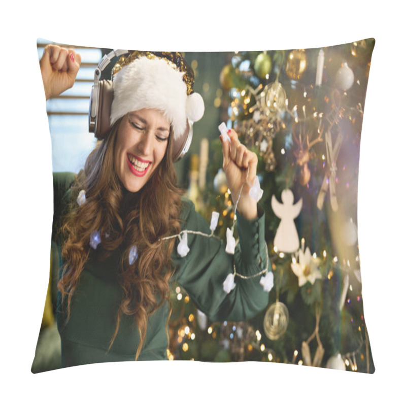 Personality  Christmas Time. Smiling Modern 40 Years Old Housewife In Green Dress Listening To The Music With Headphones And Dancing Near Christmas Tree In The Modern House. Pillow Covers