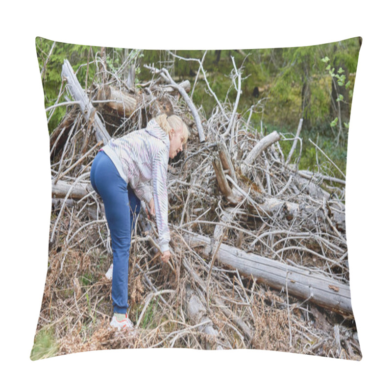 Personality  A Middle Aged Woman With Blond Hair Collects Dry Branches In The Forest. Collecting Brushwood Pillow Covers