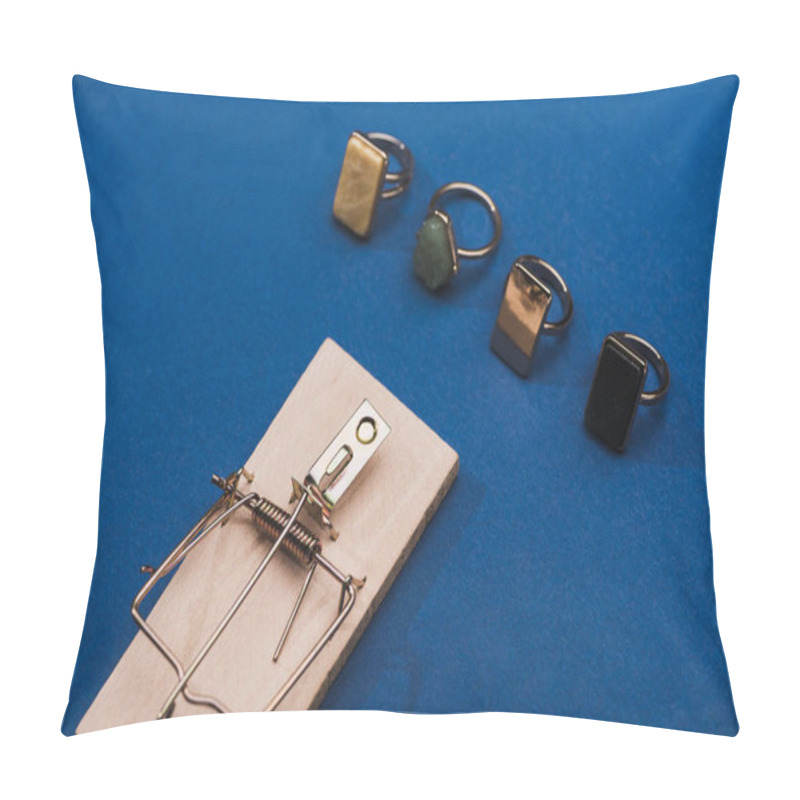 Personality  High Angle View Of Wooden Mouse Trap With Jewellery Rings On Blue Background Pillow Covers