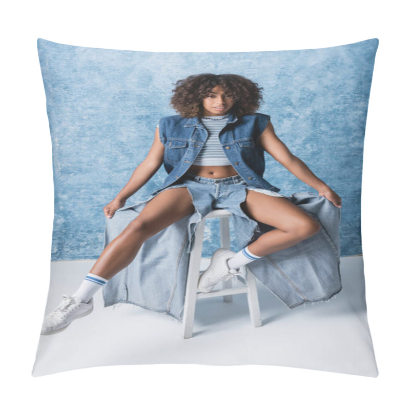 Personality  Full Length Of African American Woman In Ripped Jeans And White Sneakers Posing On Stool On Blue Background Pillow Covers