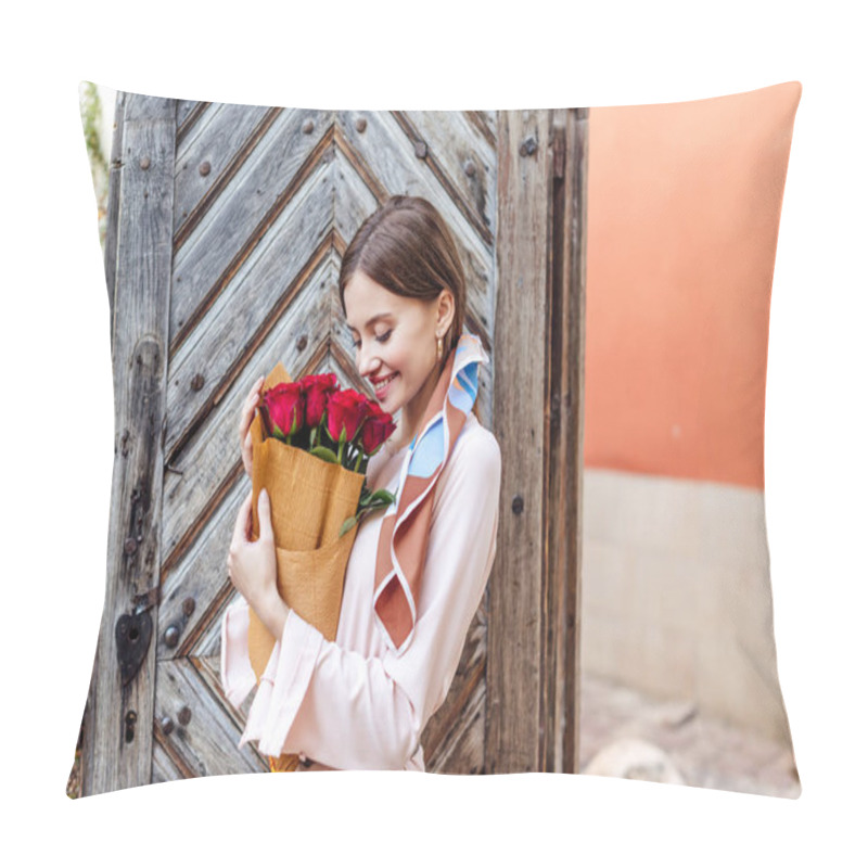 Personality  Panoramic Shot Of Happy Girl Holding Bouquet Of Red Roses While Standing Near Old Wooden Door Pillow Covers