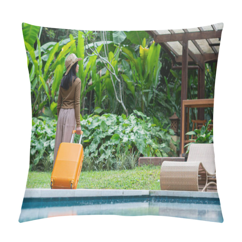 Personality  A Woman Walking By A Poolside With An Orange Suitcase, Wearing A Hat And Stylish Outfit. The Background Features Lush Greenery And A Wooden Structure, Creating A Tropical Vacation Vibe. Pillow Covers