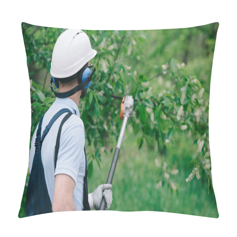 Personality  Back View Of Gardener In Helmet And Earmuffs Trimming Trees With Telescopic Pole Saw In Park Pillow Covers