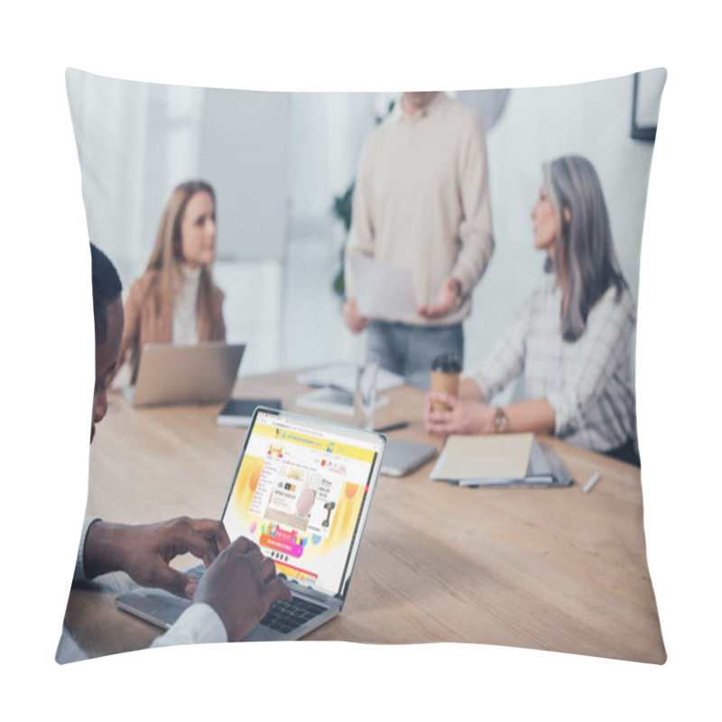 Personality  KYIV, UKRAINE - DECEMBER 6, 2019: Selective Focus Of African American Man Using Laptop With Aliexpress Website And His Colleagues Talking On Background  Pillow Covers