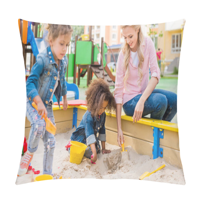 Personality  Selective Focus Of Mother Playing With Daughter And Her Little Friend In Sandbox At Playground  Pillow Covers