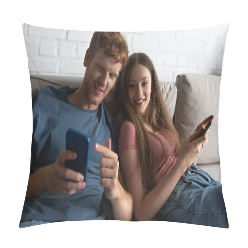 Personality  Young Man Pointing At Mobile Phone While Sitting On Couch With Happy Girlfriend In Living Room Pillow Covers