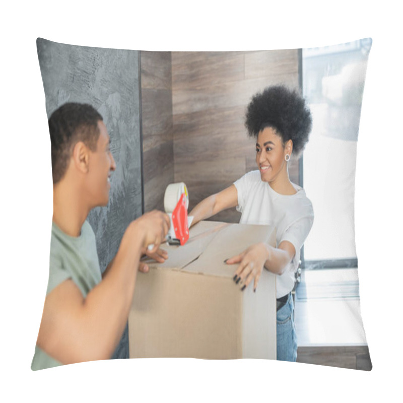 Personality  Smiling African American Woman Holding Box Near Boyfriend With Adhesive Tape During Moving Pillow Covers