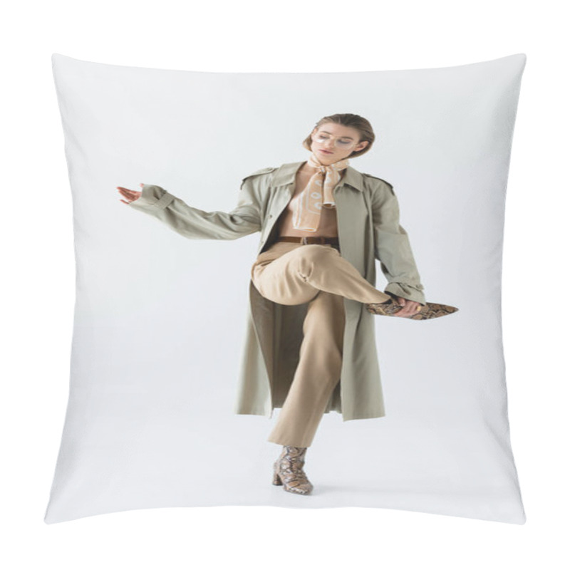 Personality  Full Length Of Young Woman In Glasses, Trench Coat And Scarf Posing On White Pillow Covers