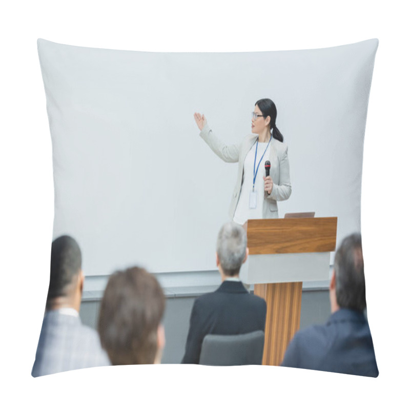 Personality  Asian Lecturer Holding Microphone And Pointing With Hand Near Blurred Audience During Seminar Pillow Covers