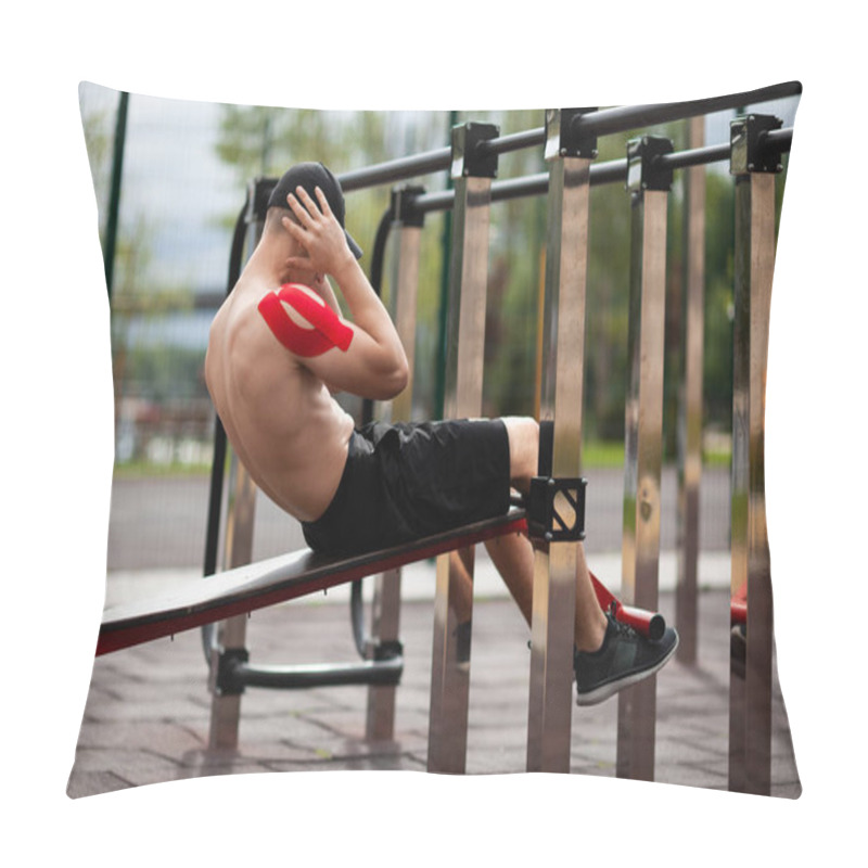 Personality  Young European Athlete With Injury Is Training Outdoors. Kinesiology ( Therapeutic, Kinesio, K-tape, KT, Physio) Tape On Shoulder. Rehabilitation And Recovery. Performing Sit Up Exercises To Strengthen Their Core Abdominal Muscles. Pillow Covers