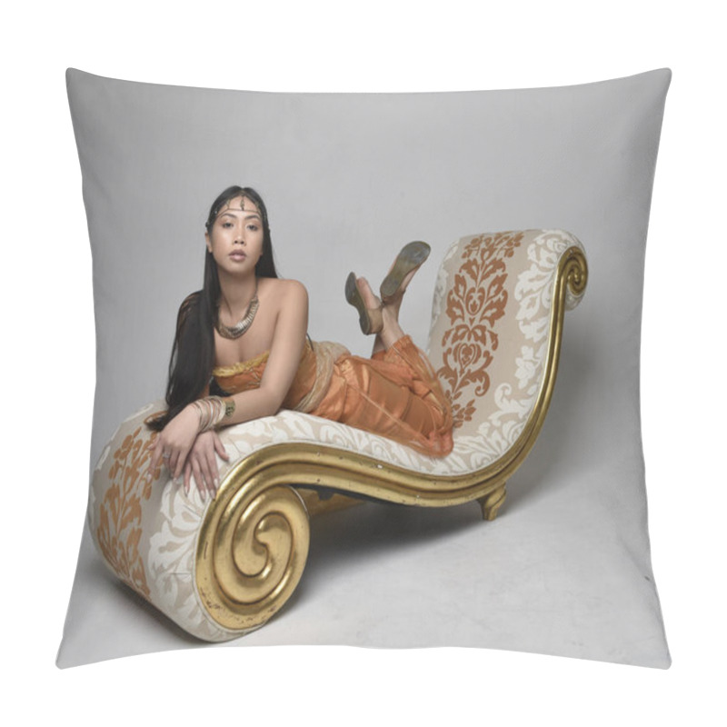 Personality  Full Length Portrait Of Pretty Young Asian Woman Wearing Golden Arabian Robes Like A Genie, Seated Pose On Lounge, Isolated On Studio Background. Pillow Covers