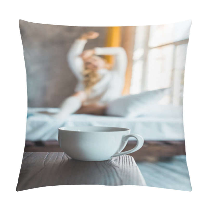 Personality  Selective Focus Of Attractive Woman In Sweater Stretching In Bedroom In Morning, Cup Of Coffee On Tabletop Pillow Covers