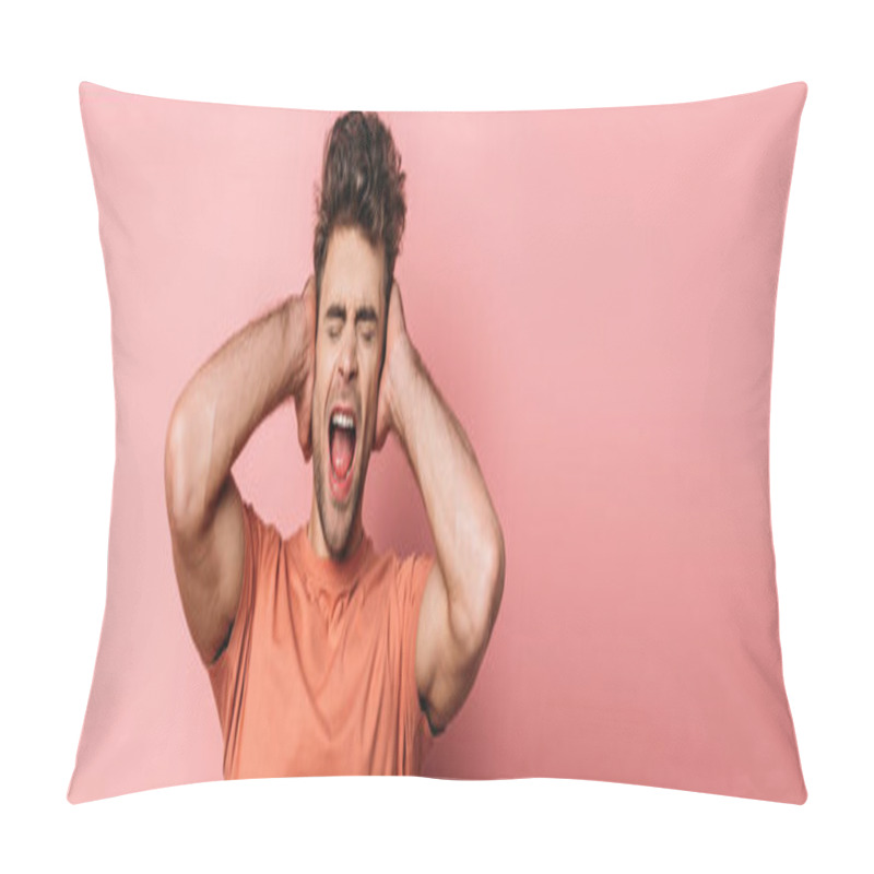 Personality  Panoramic Shot Of Irritated Young Man Shouting And Covering Ears With Hands On Pink Background Pillow Covers