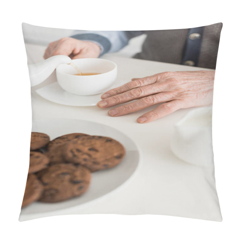 Personality  Cropped View Of Senior Man Hand On White Table With Tea Cup And Cookies Pillow Covers