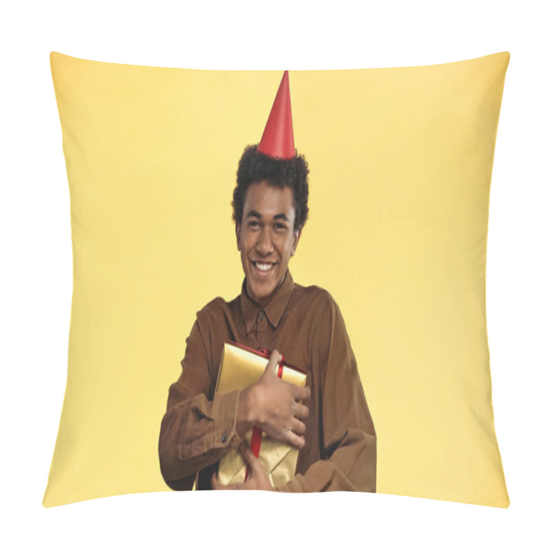 Personality  Cheerful African American Teenage Boy In Party Cap Holding Present Isolated On Yellow Pillow Covers