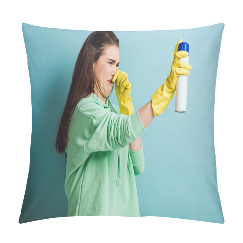 Personality  Displeased Housewife Plugging Nose With Hand While Spraying Air Freshener On Blue Background Pillow Covers