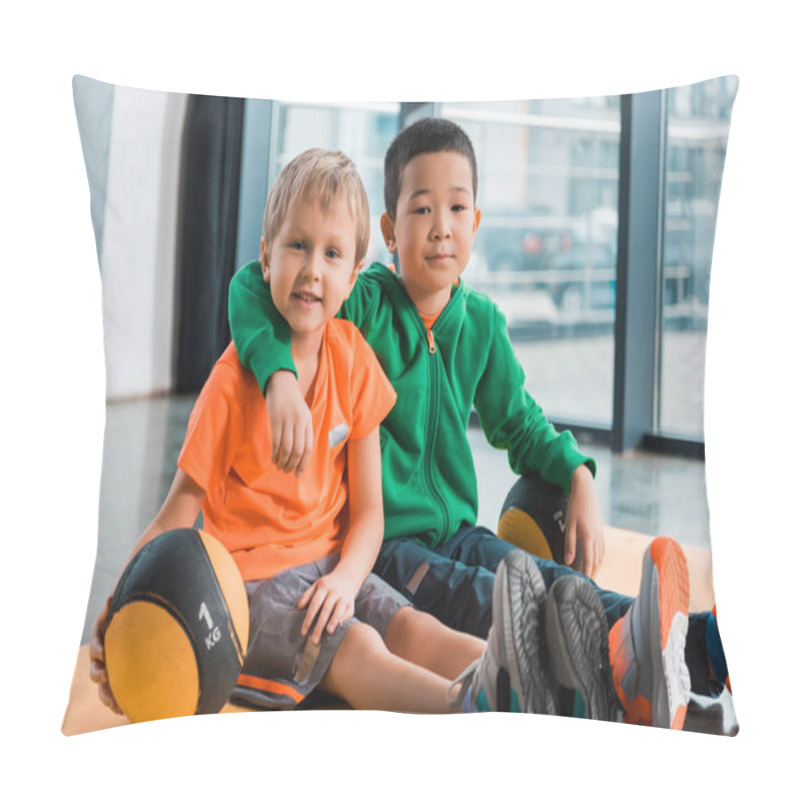 Personality  Multiethnic Boys Looking At Camera, Hugging And Sitting With Balls On Fitness Mat In Gym Pillow Covers