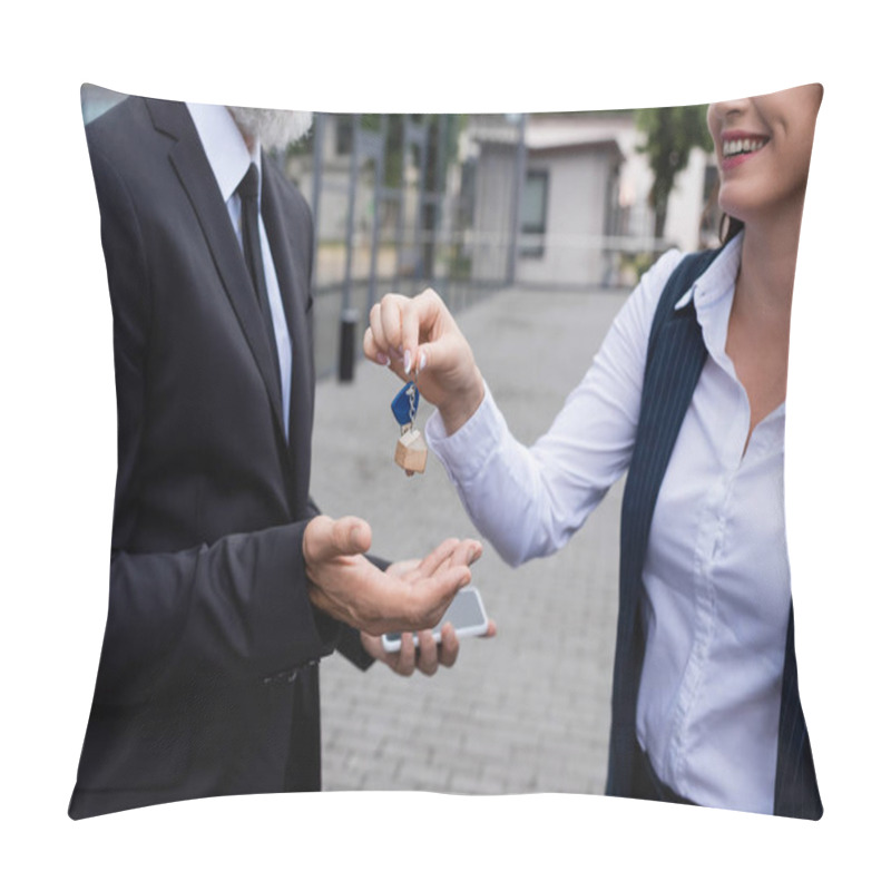 Personality  Cropped View Of Smiling Realtor Giving Key To Businessman Holding Smartphone Outdoors Pillow Covers