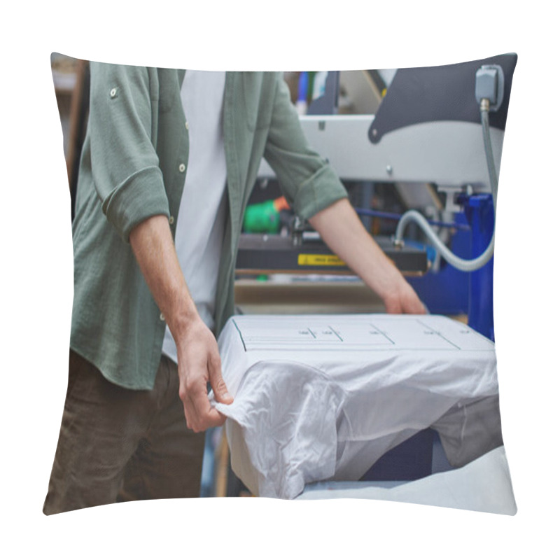 Personality  Cropped View Of Young Craftsman Holding T-shirt With Marking While Working With Screen Printing Machine In Print Studio At Background, Customer-focused Small Business Concept Pillow Covers